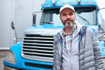 Mature man against truck