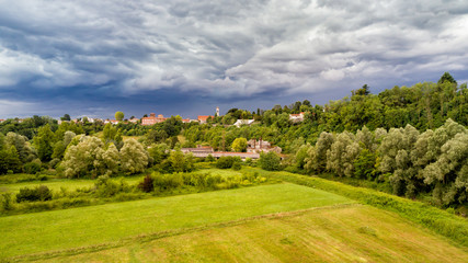 Dark heavy clouds warn of storm coming over field of Fagnano Olona in Italy.
