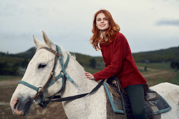 beautiful smiling woman and riding a horse
