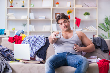 Young man working studying in messy room