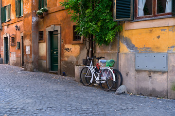 Fototapeta na wymiar italian street with byke in Trastevere, Rome, Italy