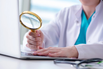 Doctor hand with magnifying glass
