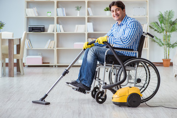 Disabled man cleaning home with vacuum cleaner