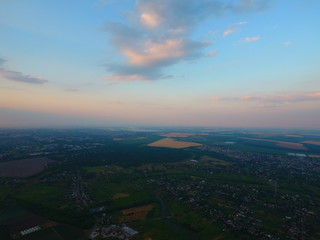 Aerial view of beautiful village, houses, roads. Sky, clouds.