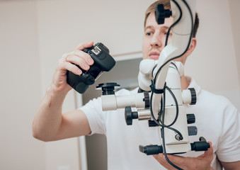 Microscope with photo camera in the dental office