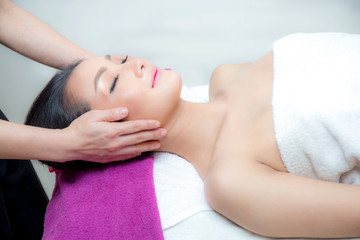 Obraz na płótnie Canvas Beautiful woman is getting a facial massage in the spa salon