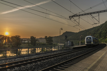 Fototapeta na wymiar Electric double deck train with sunrise