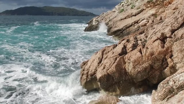 Pure Blue Waters Sea, Coastal Waves Breaking And Splashing Adventure On Sea Coast Surf Rocks. Footage. Summer