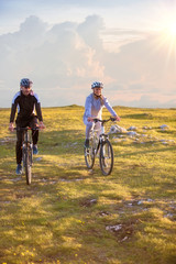 Fototapeta na wymiar Happy mountainbike couple outdoors have fun together on a summer afternoon
