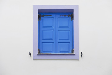 Blue window shutters and white wall 
