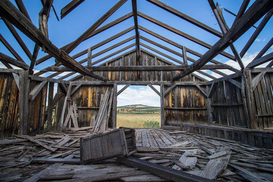 The ruins of a wooden building on the great plains, seen from the inside.