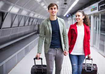 People carrying luggage at metro