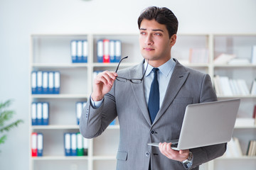 Businessman in the office working with laptop