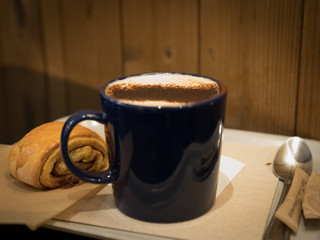 Cuppuccino and cinammon bun hearty breakfast