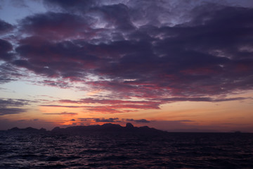 The clouds and purple red sky before sunrise in the ocean