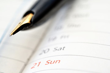 a pen on the schedule book
