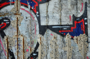 Texture of a fragment of the wall with graffiti painting, which is depicted on it. An image of a...