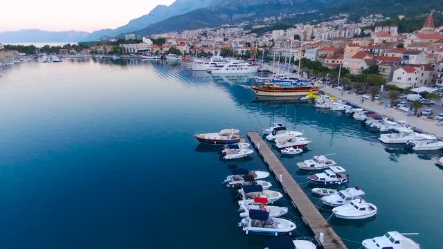 Aerial view on Makarska and marina at sunrise with Biokovo mountain in background. Makarska Riviera, Croatia 