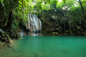 Fototapeta na wymiar Breathtaking green waterfall at deep forest, Erawan waterfall located Kanchanaburi Province, Thailand
