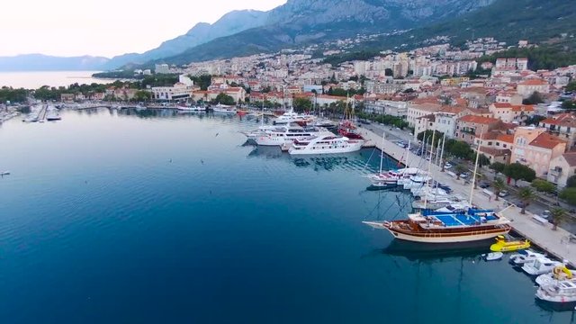 Aerial view on Makarska and marina at sunrise with Biokovo mountain in background. Makarska Riviera, Croatia 