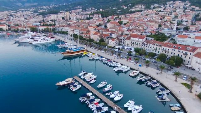 Aerial view on Makarska and marina at sunrise with Biokovo mountain in background. Makarska Riviera, Croatia 