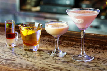 a variety of cocktails in a nightclub