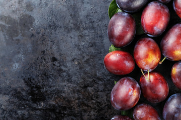 ripe plums on a black background
