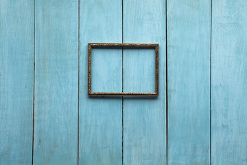 metallic photo frame on wooden wall