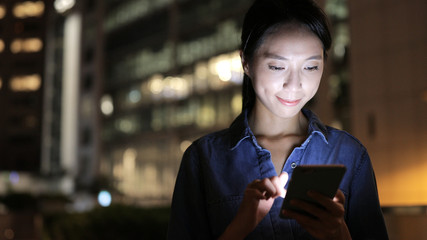 Woman use of smart phone in evening