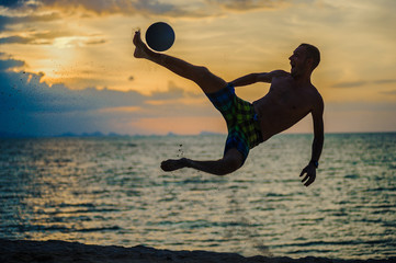 Kicking a ball. Silhouette of a man on a beach