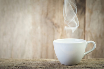 Coffee cup on wooden table On a blurred wooden board background