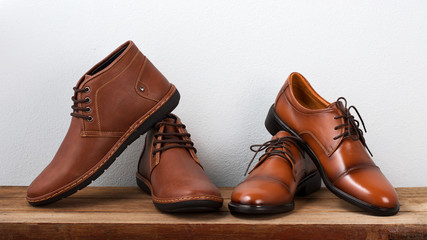 Brown fashion leather men shoes on table.