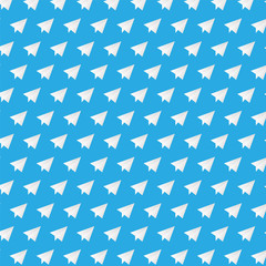White paper plane on blue background pattern