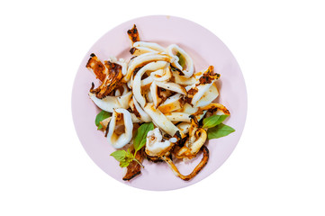 Grilled Squid with Salt and basil from top-view, Thai food..Squid tentacles and garlic saute on dish, isolated on white background.