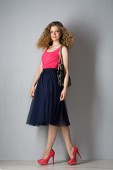 Fototapeta premium Young beautiful woman in pink shoes
