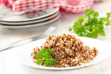 Buckwheat on a plate and fresh vegetables