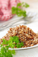 Buckwheat on a plate and fresh vegetables