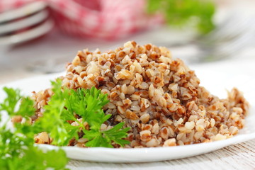 Buckwheat on a plate and fresh vegetables