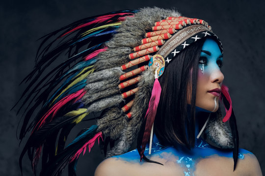 Female With Indian Feather Hat And Colorful Makeup.