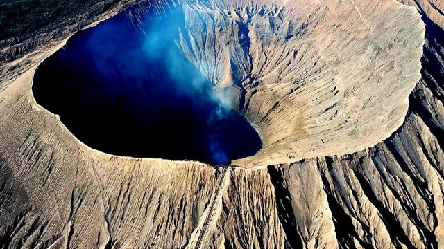 Mountain Bromo active volcano crater in East Jawa, Indonesia. Top view from drone fly. 4K footage