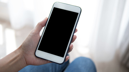 Woman hand holding phone. People using smart phone working from home.