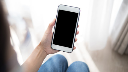 Woman hand holding phone. People using smart phone working from home.