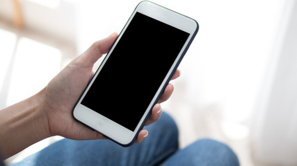 Woman hand holding phone. People using smart phone working from home.