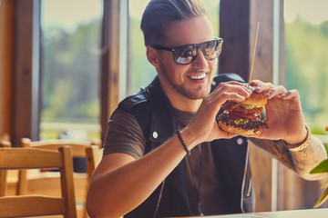 A man eating a vegan burger.