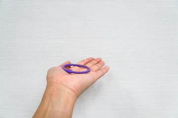 isolated woman hold purple elastic band to tie her hair
