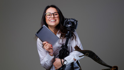 Female photographer holds tripod and tablet PC.