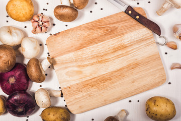 Ingredients with fresh mushrooms on wooden background. Raw organic vegetables for healthily cooking on vintage table. Top view with copy space. Vegan or diet food concept. 