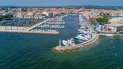 Aerial top view of boats and yachts in marina from above, harbor of Meze town, South France
