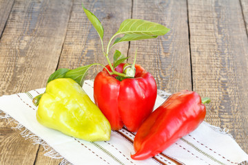 Ripe red and yellow bell peppers on wooden boards. Bulgarian or sweet peppers.
