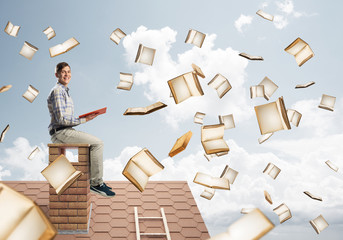 Man reading book and many of them flying in air